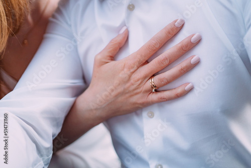 close up of a bride holding her wedding ring