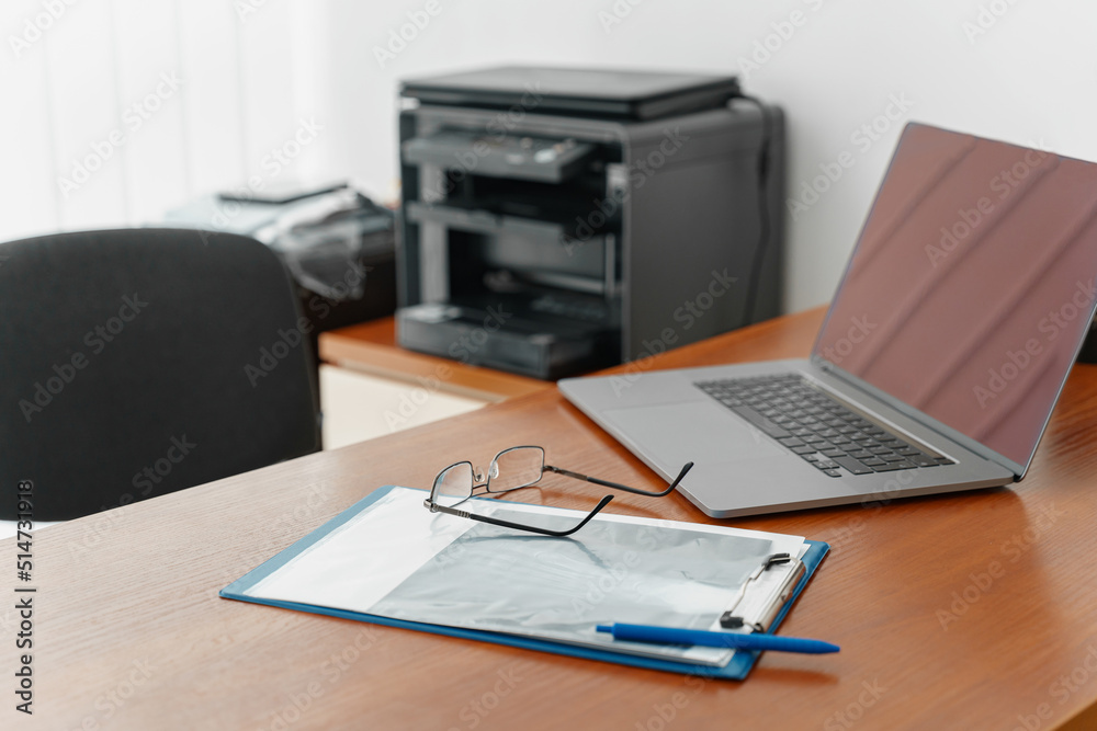 Working table of doctor therapist with laptop and medical documents ready for appointment Working table of doctor therapist with laptop and medical documents ready for appointment