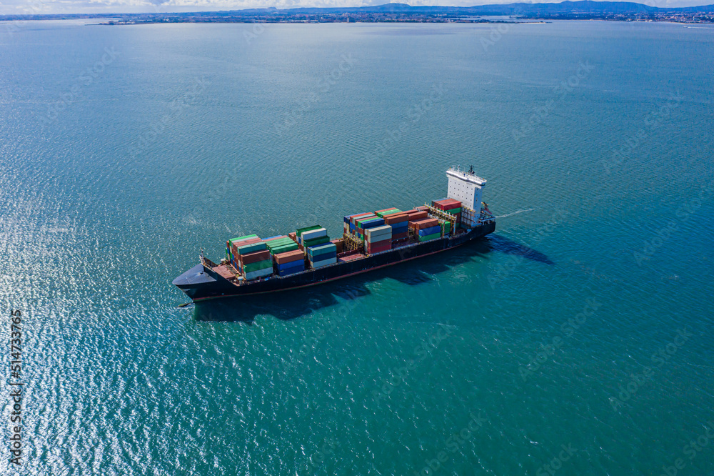 Container ship. Logistics and transportation of International Container Cargo ship in the ocean, Freight Transportation, Shipping. Aerial in front of cargo ship carrying container. 