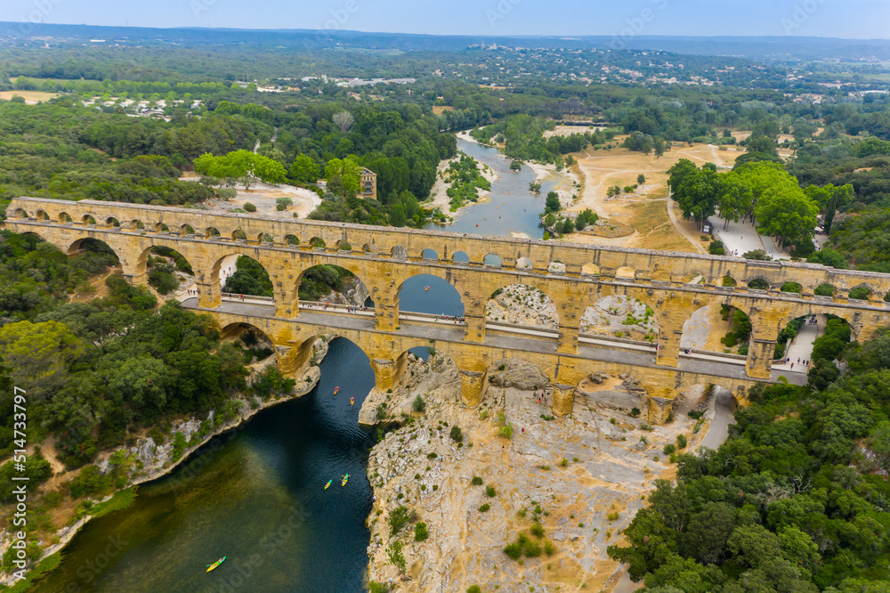 pont du gard, famous bridge in france. The aerial view of the Pont du Gard, an ancient tri-level Roman aqueduct bridge in France.  Drone Aerial Roman Aquaduct Pont du Gard ruins. 