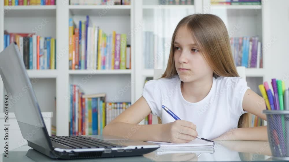 Kid Studying on Laptop in Coronavirus Pandemic, Child Learning, Writing Home, Schoolgirl Teenager Homeschooling, Online Education Kid Studying on Laptop in Coronavirus Pandemic, Child Learning, Writing Home, Schoolgirl Teenager Homeschooling, Online Education