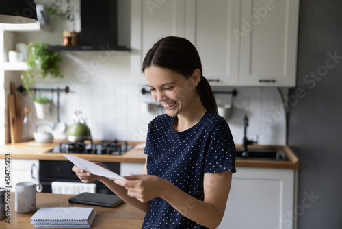 Fotografie Cheerful happy student girl reading document, receiving letter from college, bus