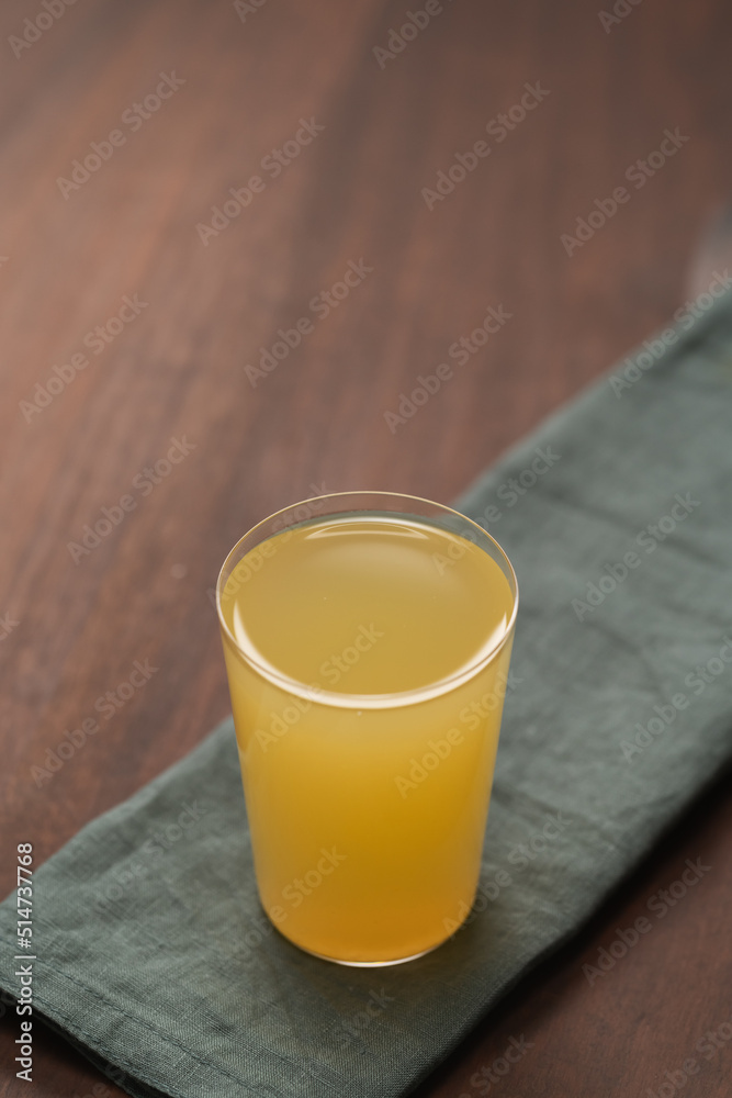 Lemonade in tumbler glass on linen napkin with copy space