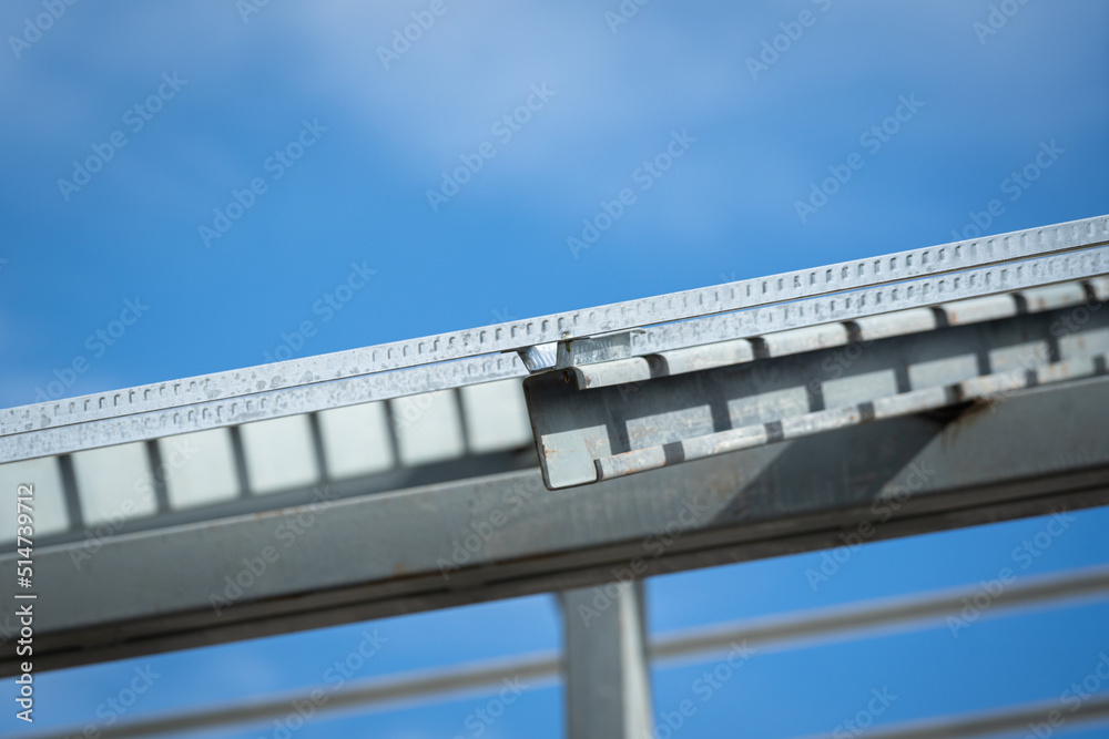 Iron beam roof structure of the house building, on blue sky background. Construction industrial working site and object photo.. Iron beam roof structure of the house building, on blue sky background. Construction industrial working site and object photo..