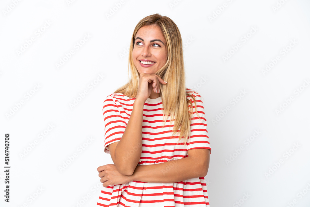 Blonde Uruguayan girl isolated on white background and looking up Blonde Uruguayan girl isolated on white background and looking up