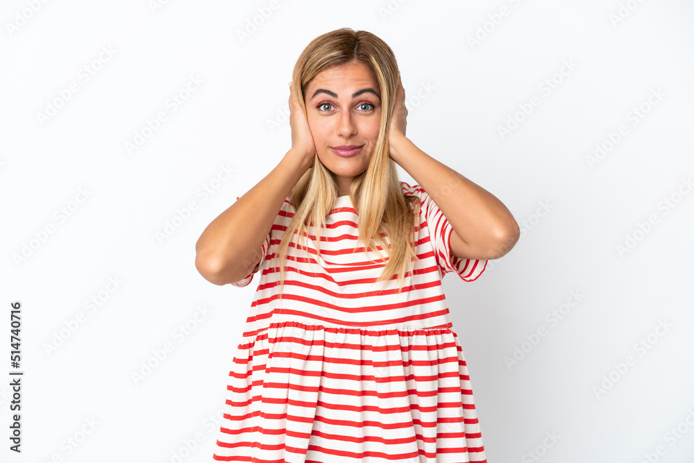 Blonde Uruguayan girl isolated on white background frustrated and covering ears Blonde Uruguayan girl isolated on white background frustrated and covering ears