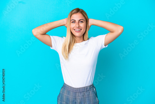 Blonde Uruguayan girl isolated on blue background laughing