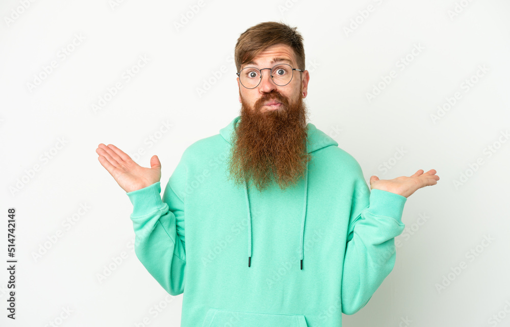 Young reddish caucasian man isolated on white background having doubts while raising hands Young reddish caucasian man isolated on white background having doubts while raising hands
