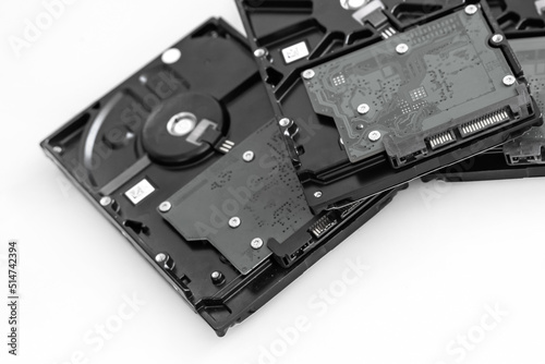 several hard drives for computer systems are located on a light background, toned image
