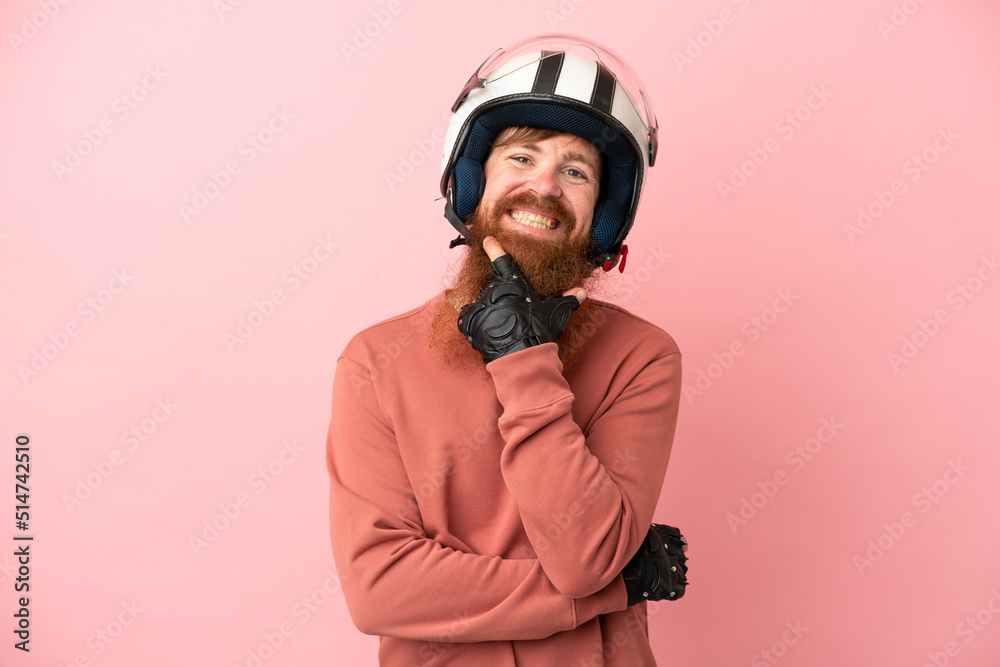 Young reddish caucasian man with a motorcycle helmet isolated on pink background happy and smiling Young reddish caucasian man with a motorcycle helmet isolated on pink background happy and smiling