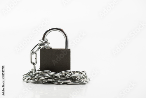 A metal chain with locked padlock on the white background symbolising closed access