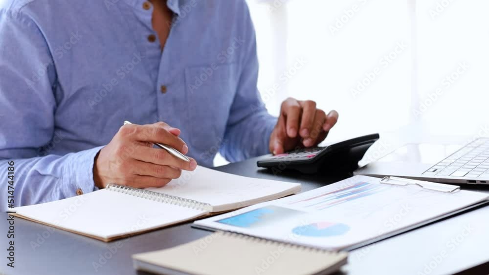 Person sitting in office with papers and laptop, businessman checking company financial and accounting summary, office work, corporate management to grow and progress. working in a company office.