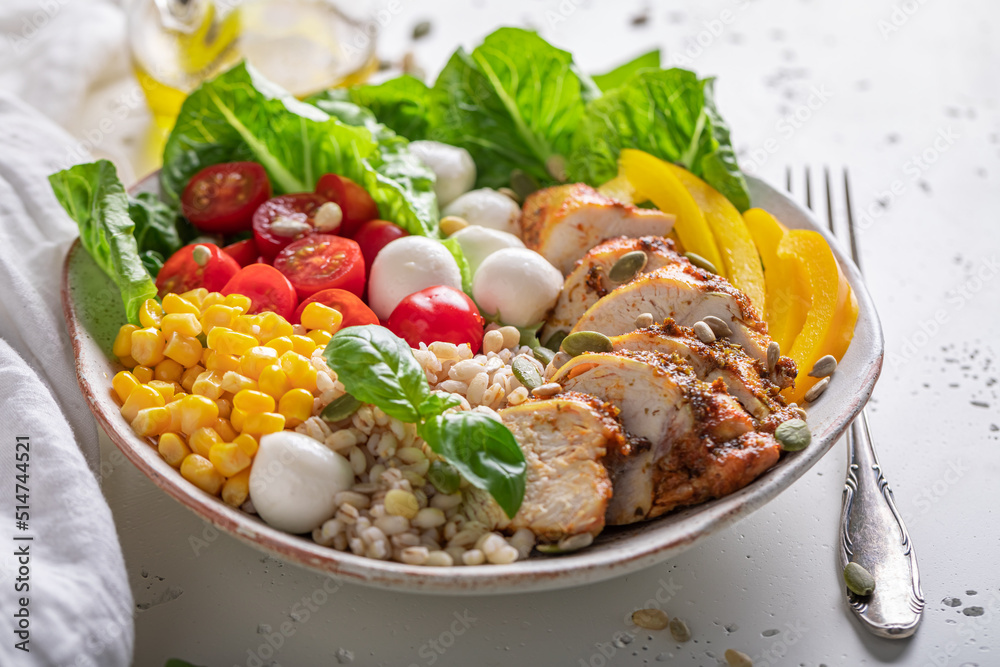 Healthy Caesar salad with groats, chicken and tomatoes.