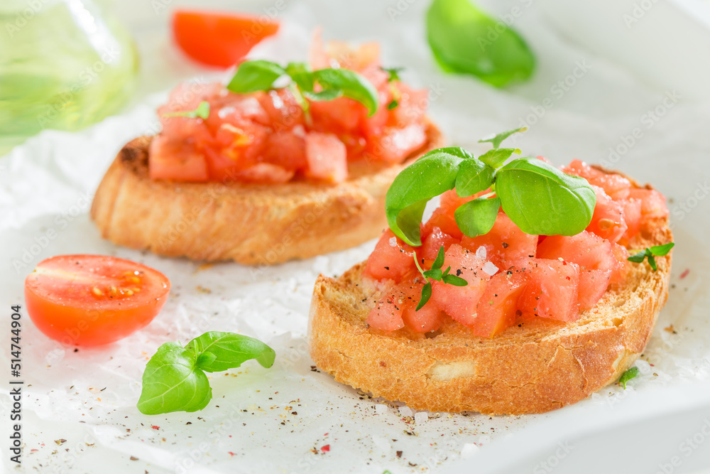 Fresh and hot bruschetta with basil and tomatoes for breakfast.