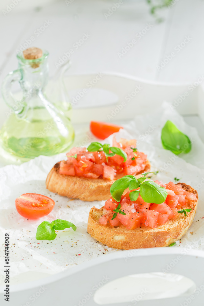 Tasty and fresh bruschetta with basil and tomatoes as snack. Tasty and fresh bruschetta with basil and tomatoes as snack.