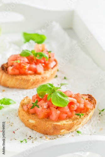 Crisp and healthy bruschetta with tomato and herbs for breakfast.