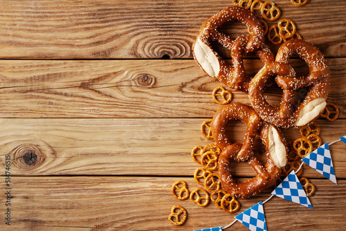 Oktoberfest concept with pretzel and blue simbol flag on wood background