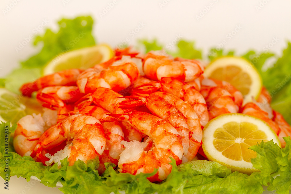 Appetizing dish with boiled shrimp, lettuce and lemon. Appetizing dish with boiled shrimp, lettuce and lemon.