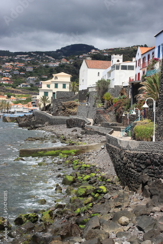 A coastal scene of a village and a winding path