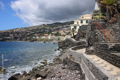 A coastal village scene with a grey sky