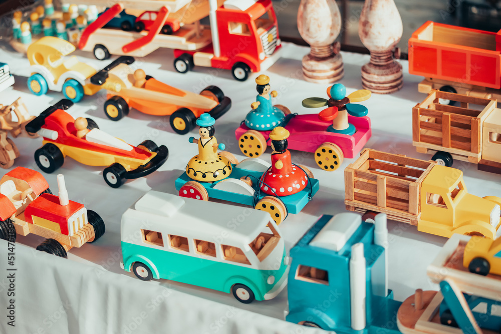 Wooden cars and other toys made by an artisan on the market. New eco materials for children and creativity