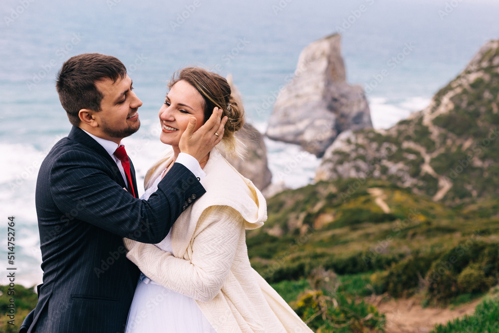 newlyweds hugging and smiling on beautiful nature background. sh