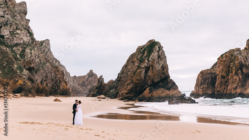 sandy shore of the ocean and high cliffs. profile of the newlywe