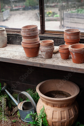 Terracotta pots and watering can in the gardener hut © Redzen