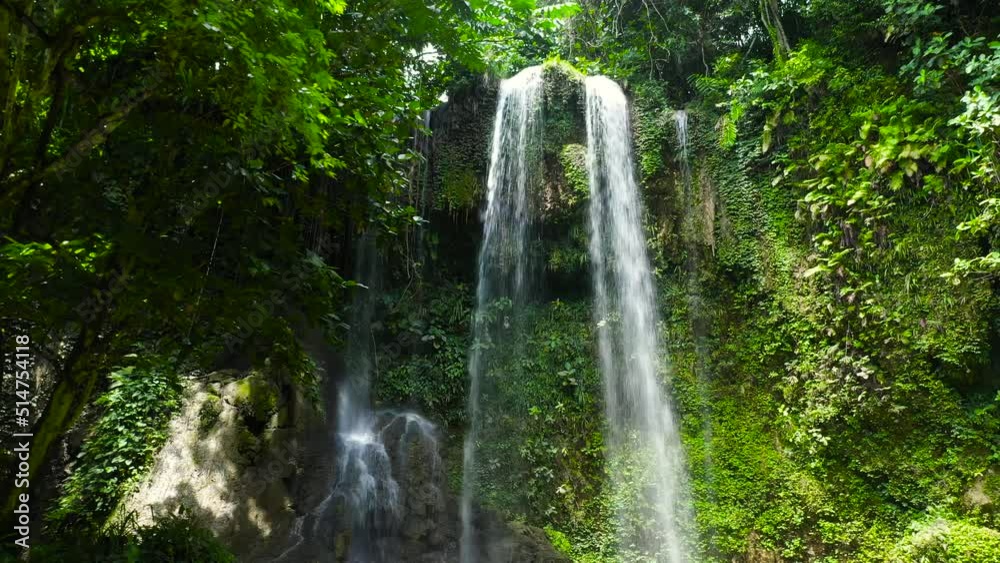 Kawasan Falls in green forest, aerial drone. Waterfall in the tropical mountain jungle. Bohol, Philippines. Kawasan Falls in green forest, aerial drone. Waterfall in the tropical mountain jungle. Bohol, Philippines.