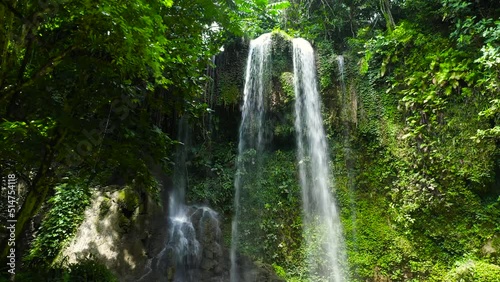 Kawasan Falls in green forest, aerial drone. Waterfall in the tropical mountain jungle. Bohol, Philippines. photo