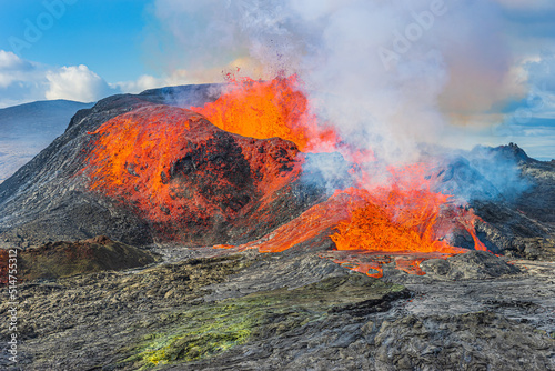 Volcanic eruption in Iceland. Volcano on Reykjanes Peninsula. strong lava flow from a volcanic crater. hot magma flows from crater. reddish and green discoloration from cold magma