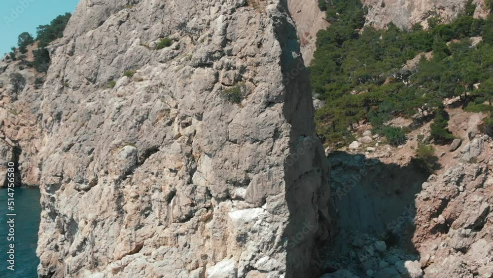 Flying near a rocky peak and sea. Cliff beautiful nature. High quality FullHD footage Flying near a rocky peak and sea. Cliff beautiful nature. High quality FullHD footage
