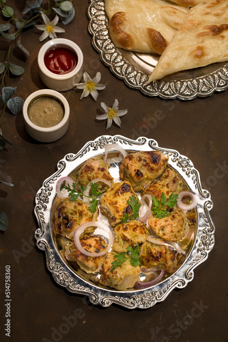 chicken malai tikka Boti seekh Kabab platter with salad in a dish top view of middle eastern barbeque dish photo