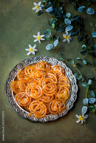 Special indian sweet jalebi or jilabi, jeelebi, and jilapi served in dish isolated on dark background top view photo