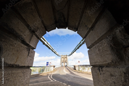 Striking view out on to the Grade I Listed Menai Suspension Bridge and A5 traffic road from an undercover open-air archway, North Wales