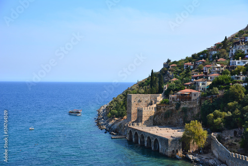 coastline with ancient fort and traditional houses and blue sea