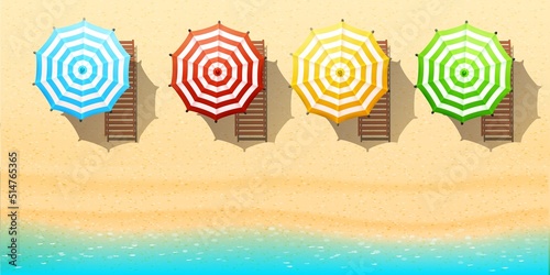 Aerial top view on the beach. Umbrellas, sunbeds, sand and ocean.