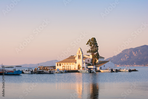 Landscape of a picturesque island with Monastery of Panagia Vlacherna in Corfu, Greece photo
