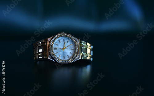 Luxury watches placed on a glittering glass floor 