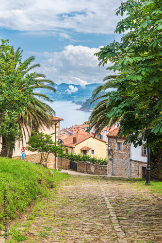Cobbled street in the upper part of the town of Lastres with the Cantabrian Sea in the background  Asturias.