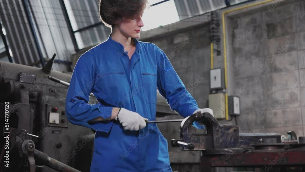 Young people worker in protective uniform operating machine at factory Industrial.People working in industry.Portrait of Female Engineer looking camera at work place.	
