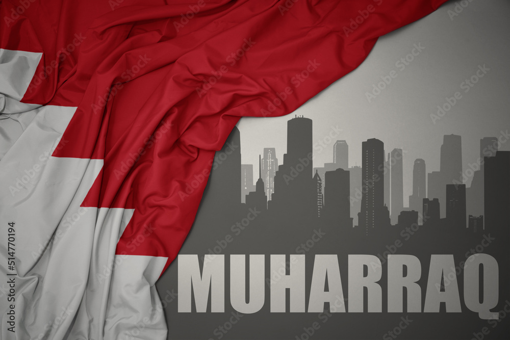 abstract silhouette of the city with text Muharraq near waving national flag of bahrain on a gray background.3D illustration