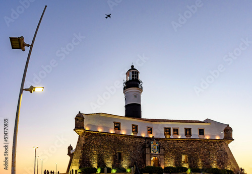 Famous Barra lighthouse in the city of Salvador in Bahia during sunset photo