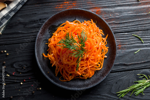 Korean carrot on black plate top view photo