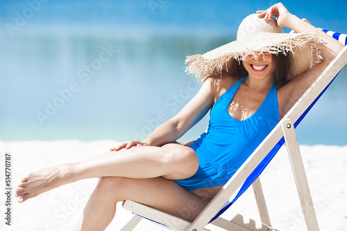 Attractive young woman on the beach. Sexy young lady on the sea shore.Female relaxing on resort. Model on seaside.