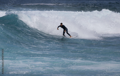 PUERTO DE SANTIAGO  TENERIFE - JUNE 2022  surfer riding the waves in Tenerife