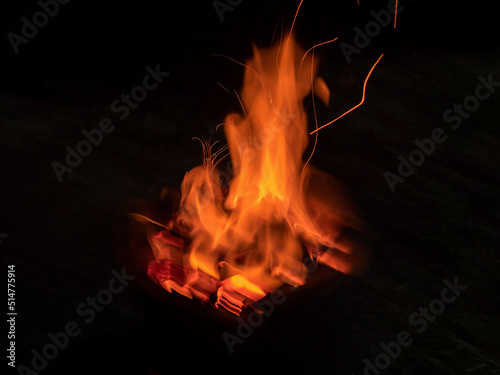 Flames radiate orange lines on a black background.