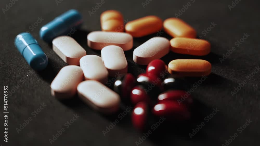 Pills Medical pills and capsules with light effect Isolated on a black background 4k Pills Medical pills and capsules with light effect Isolated on a black background 4k