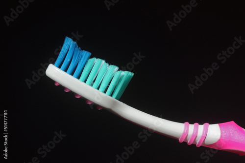 toothbrush isolated on the dark and white background without toothpaste. Nylon bristles and plastic handles