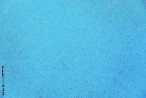 bright blue background mottled with grey sparkles